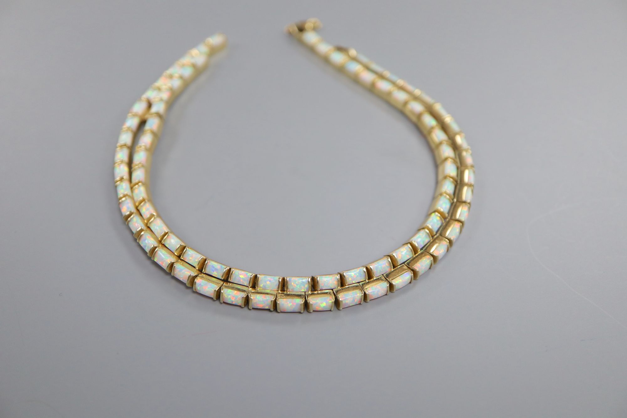 A modern stylish 750 yellow metal and white opal set necklace and pair of matching drop earrings,